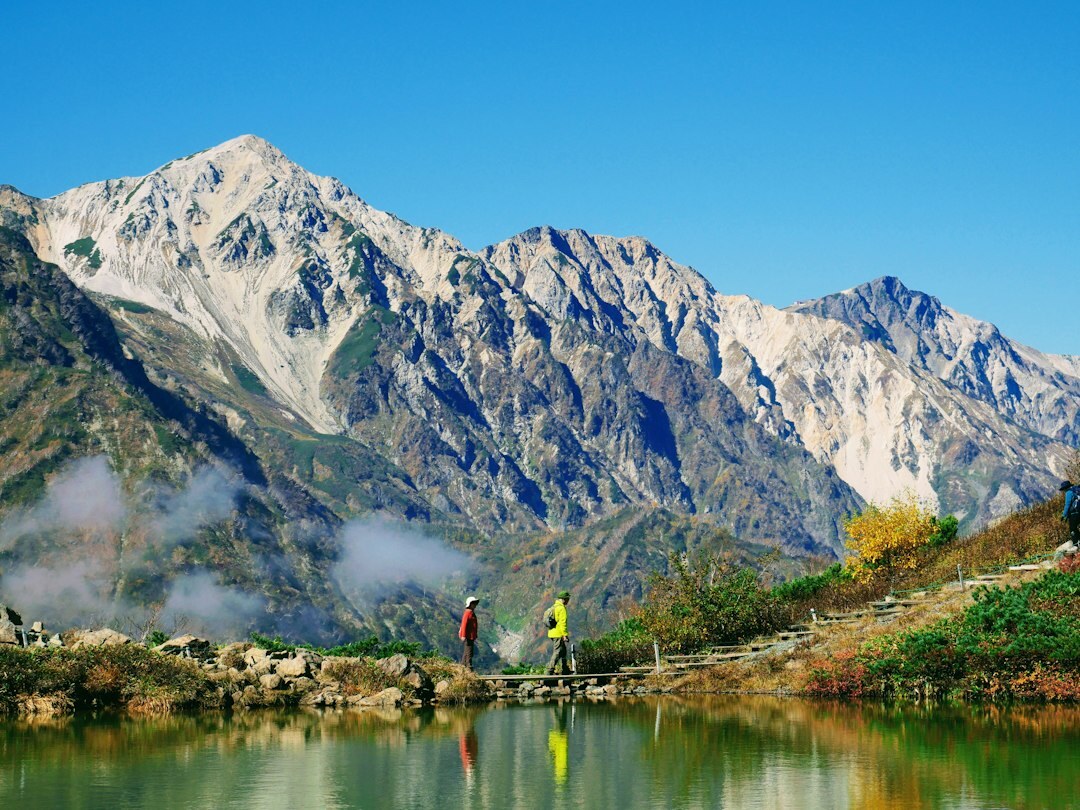 Japanese senior hiking group walking on a mountain trail